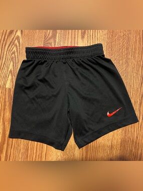 Nike boys Black Athletic Shorts with Red Swoosh size 4/xs
